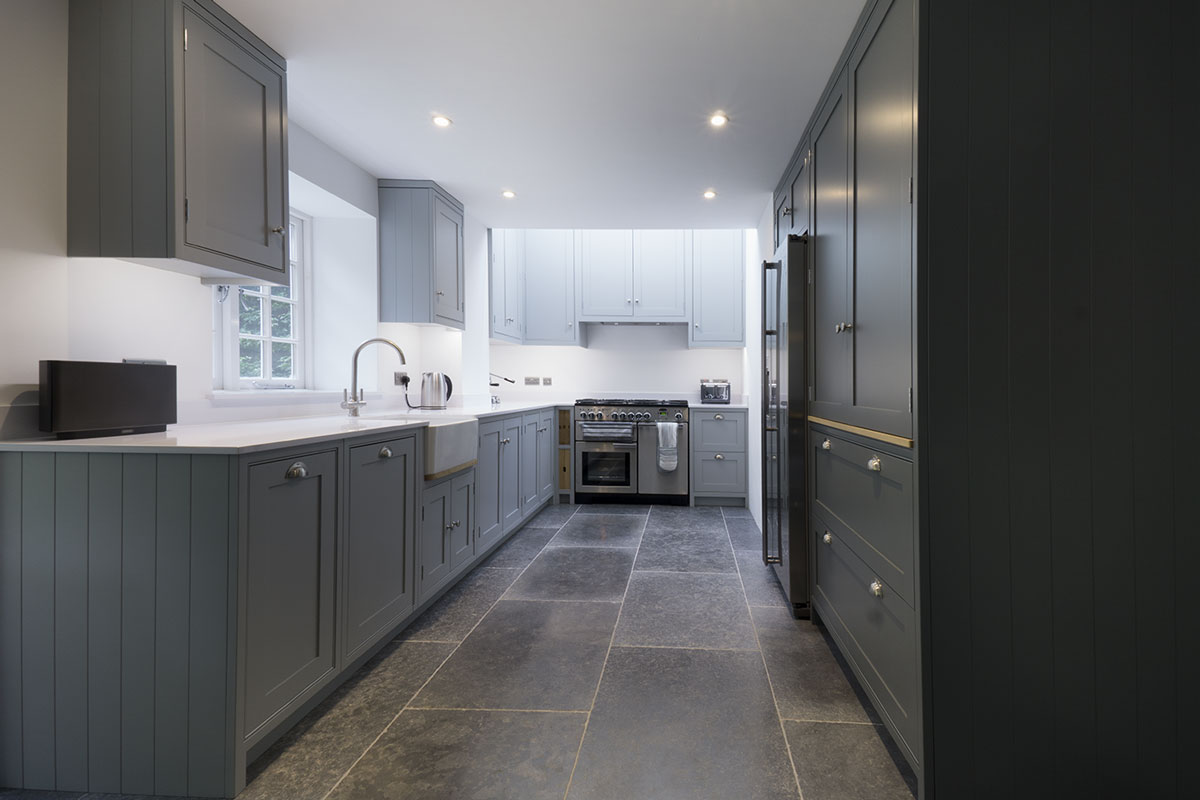 Modern dark kitchen with range and seperate larder and full height fridge