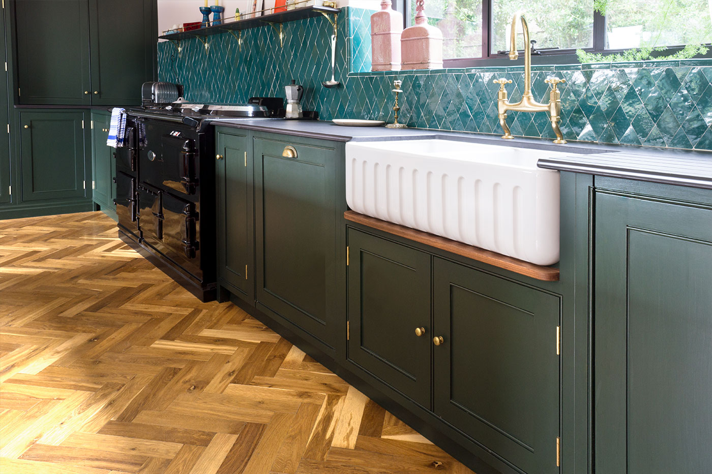 Open plan traditional kitchen, in a dark green, with slate